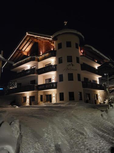 a large building in the snow at night at Almtraum Berwang in Berwang