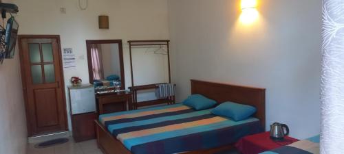 1 dormitorio con 1 cama con almohadas azules en Dad's Holiday Home, en Matale