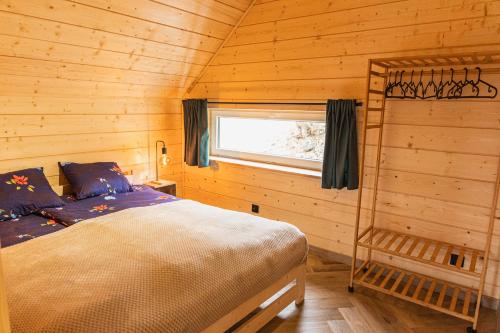 a bedroom with a bed in a log cabin at Stodoła pod Pilskiem in Korbielów