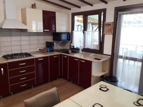 een keuken met bruine kasten en een aanrecht bij Olga house Deva in Deva