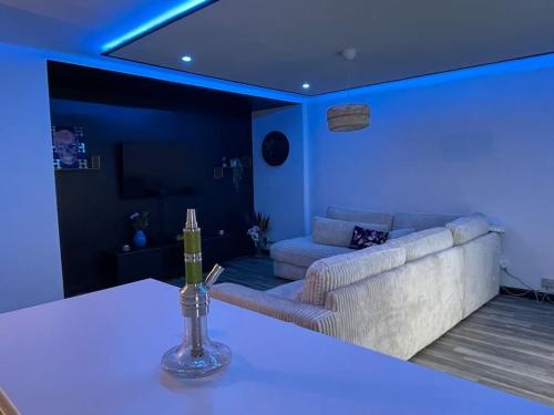 a living room with a couch and blue lighting at Spa House , love room in Tremblay En France