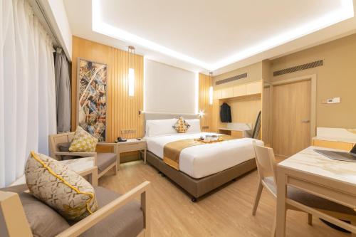 a hotel room with a bed and a desk at Glenmarie Hotel and Golf Resort in Shah Alam