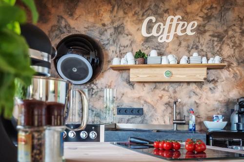 a kitchen with a coffee sign on the wall at MöhneSeeBlick in Möhnesee