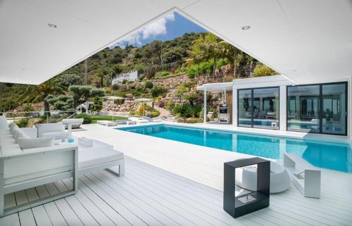 a large house with a swimming pool and a house at Ibiza Style Barcelona in Badalona