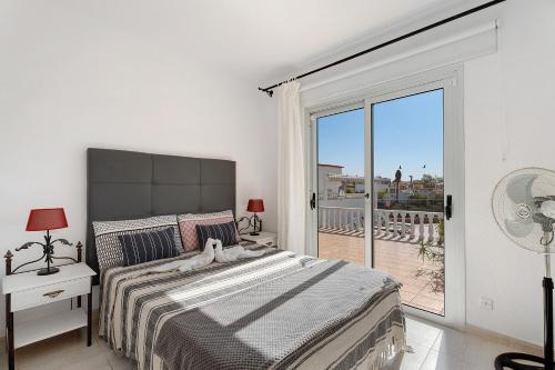 a bedroom with a bed and a large window at Villa Milena in Callao Salvaje