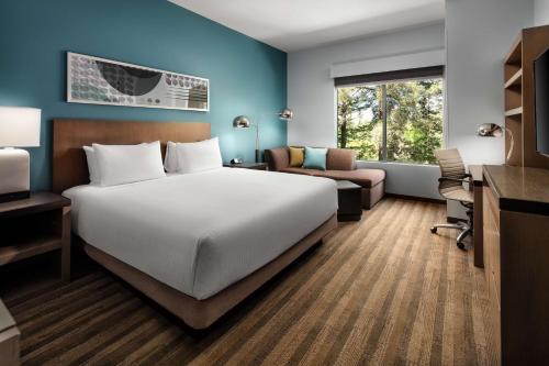 a hotel room with a bed and a desk at Hyatt House San Jose/Cupertino in Cupertino