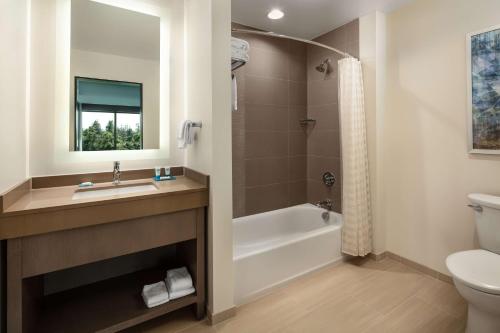 a bathroom with a sink and a tub and a toilet at Hyatt House San Jose/Cupertino in Cupertino