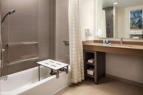 a bathroom with a shower and a sink and a tub at Hyatt House San Jose/Cupertino in Cupertino