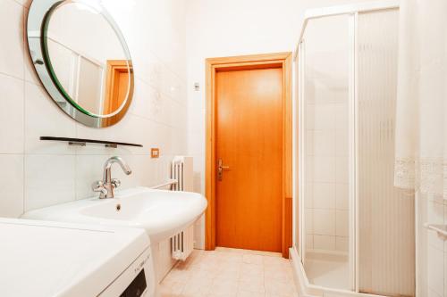 a bathroom with a sink and a mirror and a shower at Center Apartament-Housea Travel in Polignano a Mare