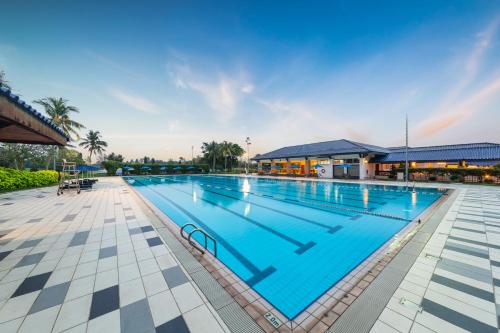 a large swimming pool with blue water at Glenmarie Hotel and Golf Resort in Shah Alam