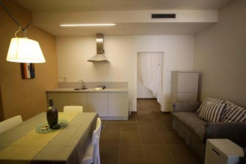 a living room with a couch and a table at Castellabate House in Santa Maria di Castellabate