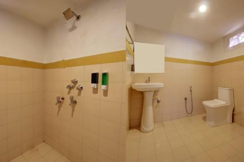 a bathroom with a sink and a toilet at Calangute Cosy 1 bhk Apartment in Calangute