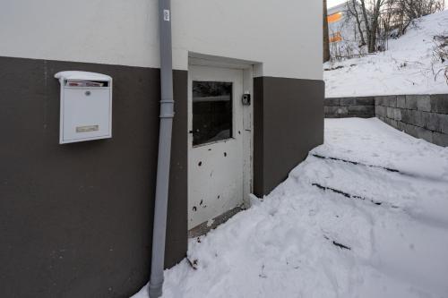 a door in a building with snow around it at Day Dream Central Akureyri Basement Studio in Akureyri