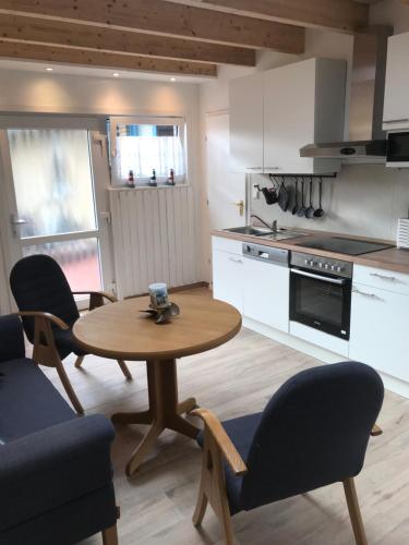 a kitchen with a table and chairs in a kitchen at Zum Hanseaten in Borkum