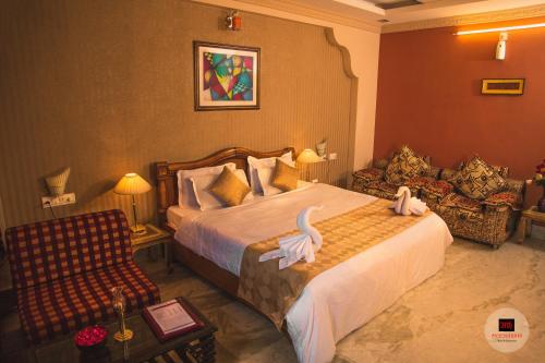 Een bed of bedden in een kamer bij Hotel Meenakshi Udaipur - Family Preffered Hotel