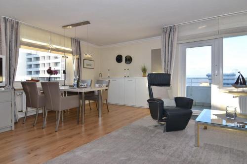 een keuken en een woonkamer met een tafel en stoelen bij Atlantik, Whg 23, Seeseite in Westerland