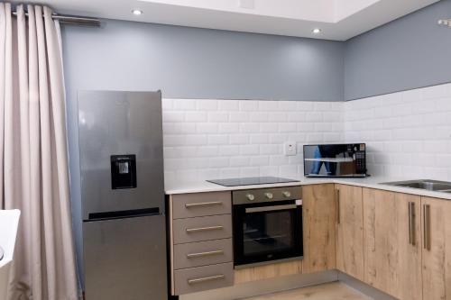 Kuchyň nebo kuchyňský kout v ubytování Uptown Apartments - Casalinga Villas