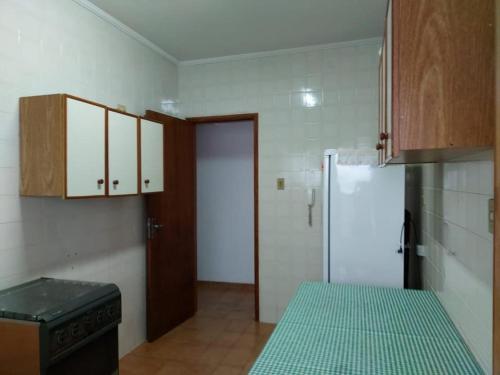 een keuken met een fornuis en een koelkast. bij Apartamento Praia Grande Frente Mar in Praia Grande