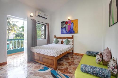 a bedroom with a bed and a couch at Comfort Holiday Home in Baga