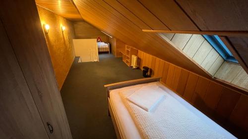 an attic view of a room with a bed and a table at Apartment in Laatzen! contactless check-in in Hannover