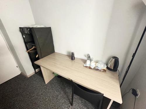 a wooden desk in a room with a shelf at Fantastic - NS54 Room F in Warsaw