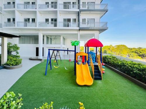 a playground on a lawn in front of a building at * * WV 3 Peaceful Pinnacle in Iloilo City