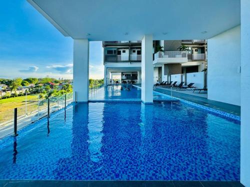 a large swimming pool in a building with blue water at * * WV 3 Peaceful Pinnacle in Iloilo City