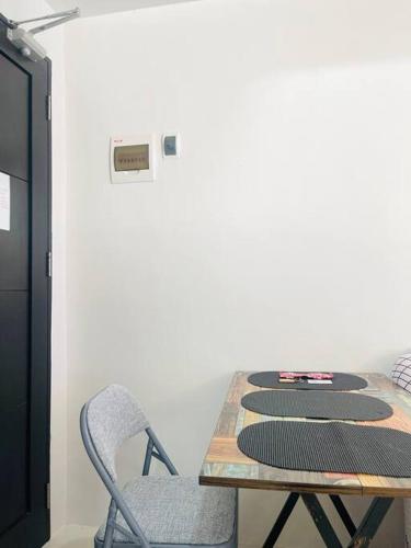 a table and a chair in a room at * * WV 3 Peaceful Pinnacle in Iloilo City