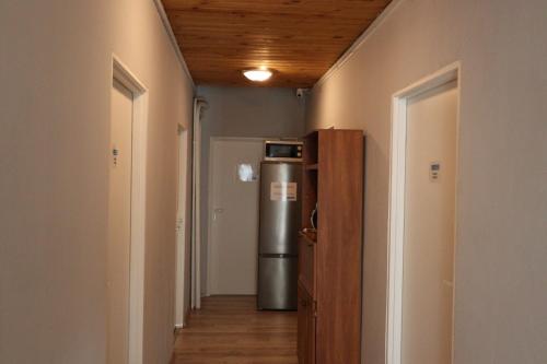 a hallway with a refrigerator in a room at Fantastic - NS54 Room F in Warsaw