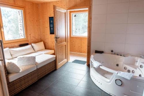 uma casa de banho com uma banheira e um sofá. em Abrahamhütte em Kaiser