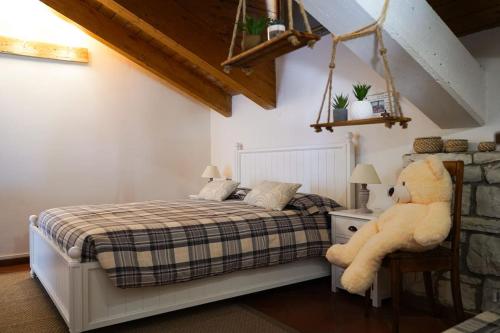 a bedroom with a bed with a large teddy bear at COUNTRY HOUSE LA MIA TERRA in Angera