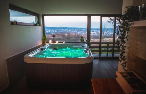 a hot tub in a room with a large window at LIPA houses & spa in Sopot