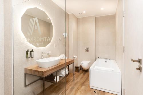 a bathroom with a sink and a toilet at Atmosphere Balneo Hotel & SPA in Pavel Banya