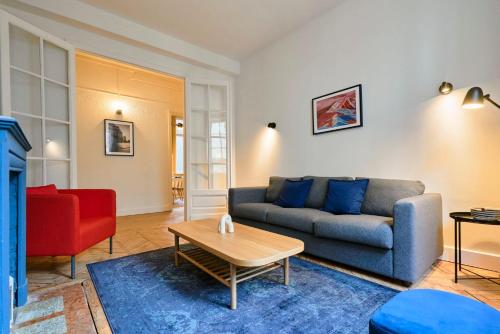 a living room with a couch and a table at 3 bedroom apartment, close to all amenities in Lille