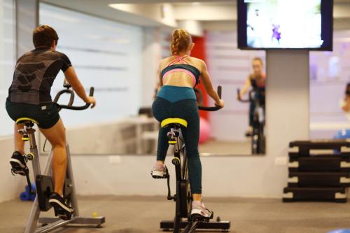 a man and a woman riding bikes in a gym at Bahia Principe Fantasia Punta Cana - All Inclusive in Punta Cana