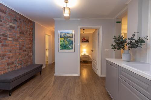 a living room with a couch and a brick wall at Day Dream Soleyjargata Rooms & Apartments in Reykjavík