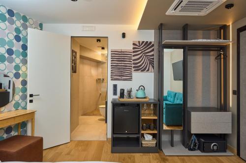 a room with a loft bed and a bathroom at SIGMA Suites Hotel in Thessaloniki