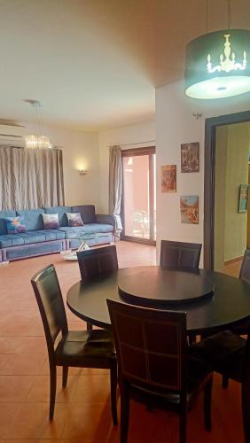 a living room with a table and chairs and a couch at Villa Private pool cancun El Ain El Sokhna 63 in Ain Sokhna