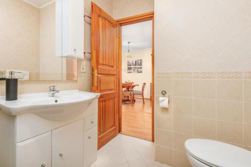 a bathroom with a sink and a toilet at Thermal Valley Apartman - Batthyány Villapark in Zalacsány