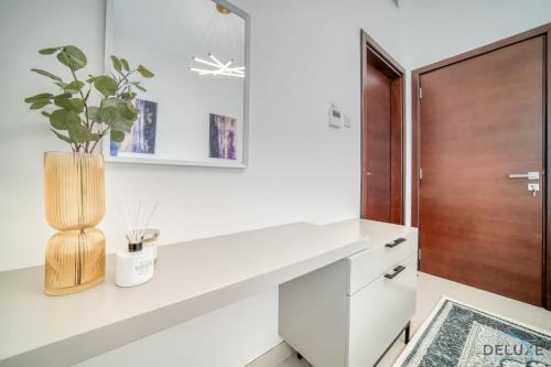 a kitchen with a white counter and a wooden door at Best Deal, Classy 4BR Villa with Pool & Ocean Views by Deluxe Holiday Homes in Fujairah