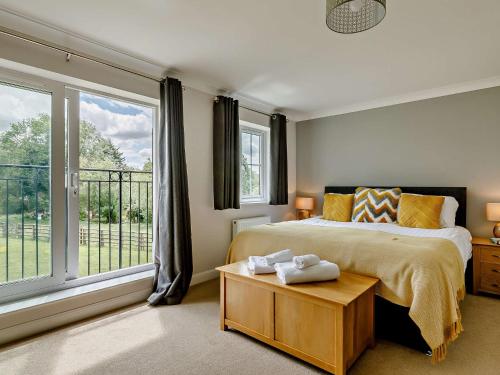 a bedroom with a bed and a large window at 3 Bed in Bridgwater 90939 in North Petherton