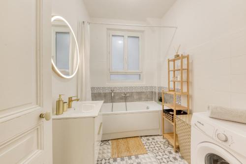 a white bathroom with a tub and a sink at -L'émeraude de Louis XVI- Idéal pour Couple-Solo-Pro 8min de Paris-1min de la gare in Enghien-les-Bains