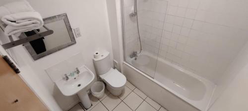 a bathroom with a toilet and a sink and a shower at Royal Hotel, Bar & Grill in Purfleet