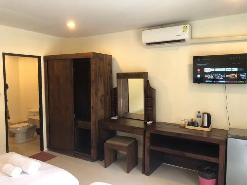 a bathroom with a vanity with a mirror and a sink at Rawai Sea Beach in Phuket Town