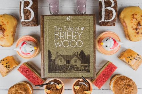 a book sitting on top of a table with breads at Briery Wood Hotel in Ambleside