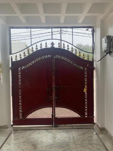 a large wooden gate in a room at 164 N Ashiyana in Lucknow