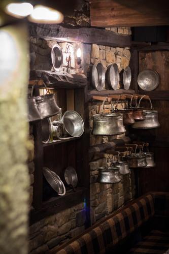 a kitchen with pots and pans on a wall at Family Hotel Strannopriemnitza in Oreshak