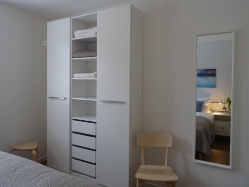 a bedroom with a closet with a mirror and a bed at Hangar 19 Seebrise in Schwerin