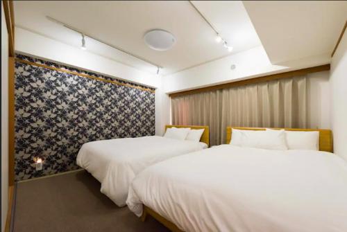 A bed or beds in a room at ShibuyaHachiko 6min walk#Easy to many hotspot#Max6