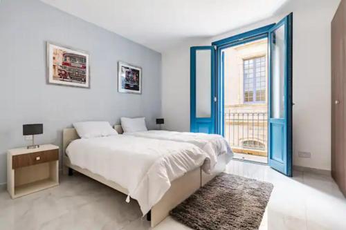 a bedroom with a bed and a large window at Sea View Luxury Apartment Brand New in Valletta in Valletta